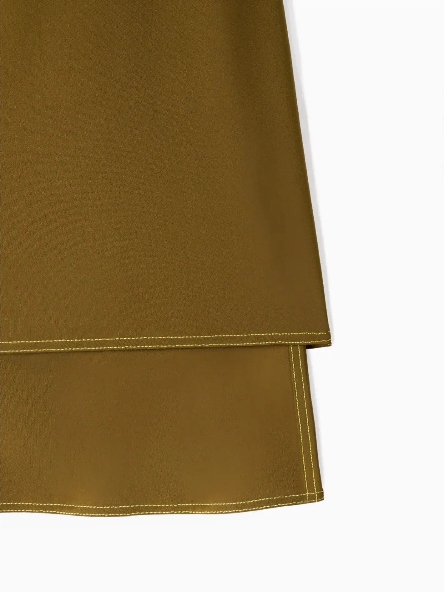 A Panta Skirt Olive Green by Sunnei is centered against a plain white background. The skirt, available at Bassalstore in Barcelona, has a straight cut, with the top layer ending above the second layer, creating a tiered look.