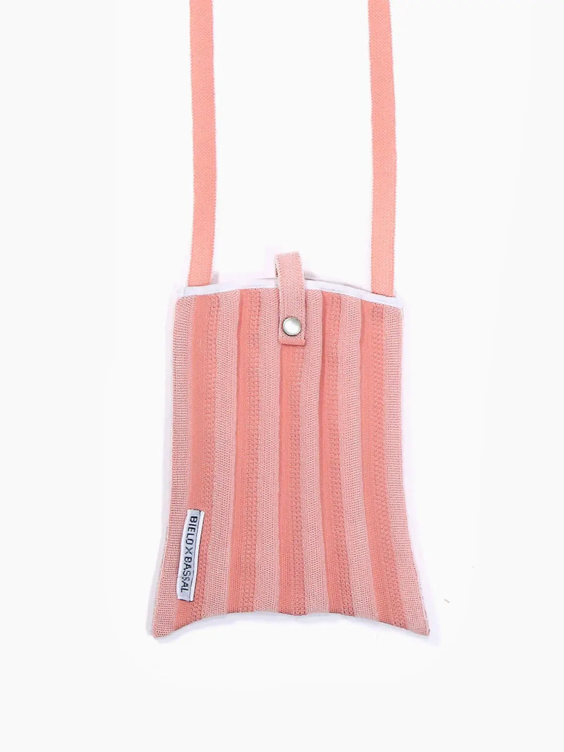 A pink and white striped fabric Pink Shoulder Bag with a top snap closure and a long strap. The Pink Shoulder Bag, available on BassalStore, has a small label on the side that reads "STICK with STYLE." The background is white, making it perfect for your next shopping trip in Barcelona.