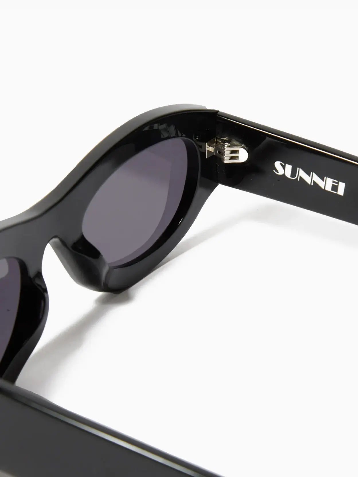 A pair of Prototipo 5 Sunglasses Black with dark lenses, featuring a subtle "Sunnei" logo on the left lens, available at Bassalstore in Barcelona.
