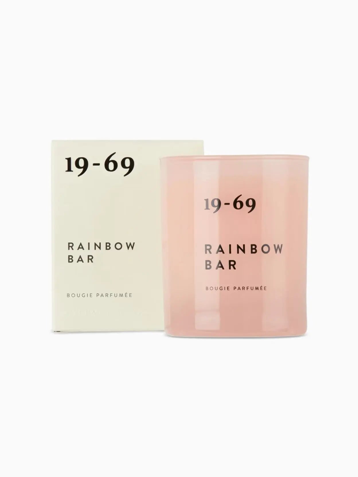 A pink candle labeled "Rainbow Bar Candle 200ml" by 19-69 in black text is displayed against a white background. The candle has a minimalistic design with its name and type "BOUGIE PARFUMÉE" printed below the main label, available exclusively at Bassalstore in Barcelona.