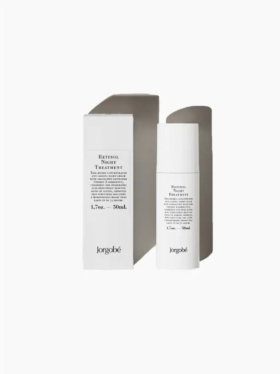 A white bottle of Jorgobé Retinol Night Treatment 50ml is positioned in front of its matching white box. The box displays the product name and details in black text. Both the bottle and the box stand against a plain white background, available exclusively at our bassalstore in Barcelona.