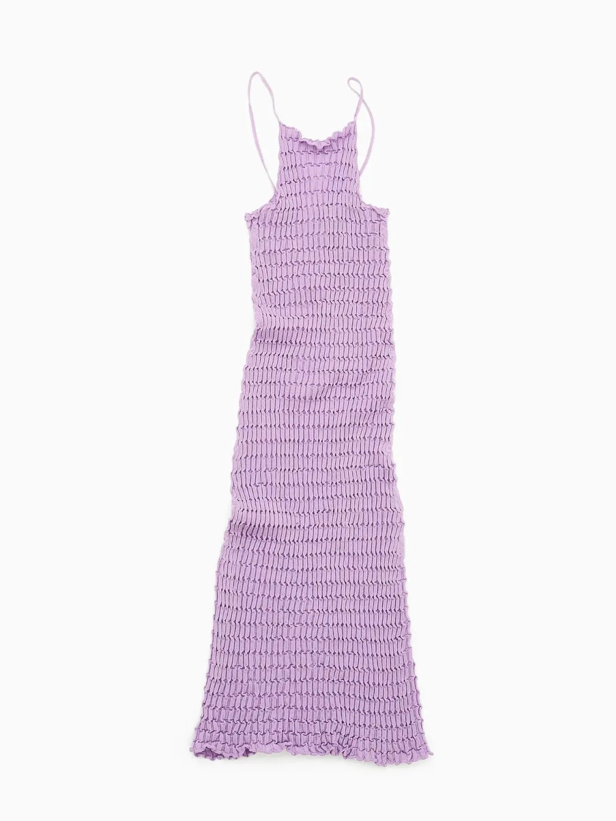 A Rina Dress Pink from Rus featuring a unique textured pattern with intricate, scalloped detailing. The dress has thin spaghetti straps and a long, flowing hem, giving it a stylish and elegant appearance perfect for exploring the streets of Barcelona.