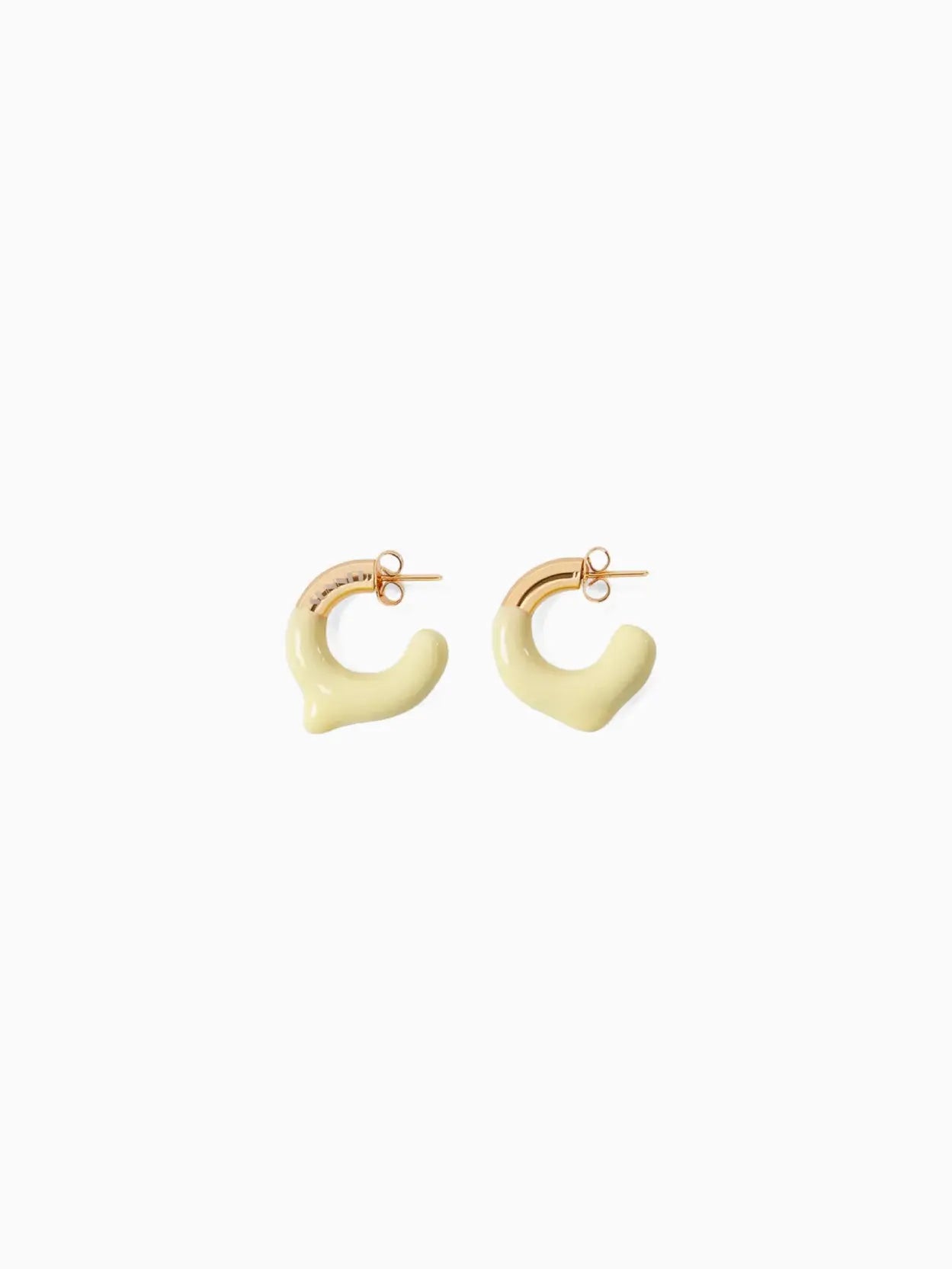 A pair of contemporary Rubberized Small Earrings by Sunnei featuring a unique, smooth, abstract shape. The earrings have a gold-toned attachment with a yellowish, irregularly curved resin design, giving them a modern and artistic appearance. Available at BassalStore in Barcelona. The background is plain white.