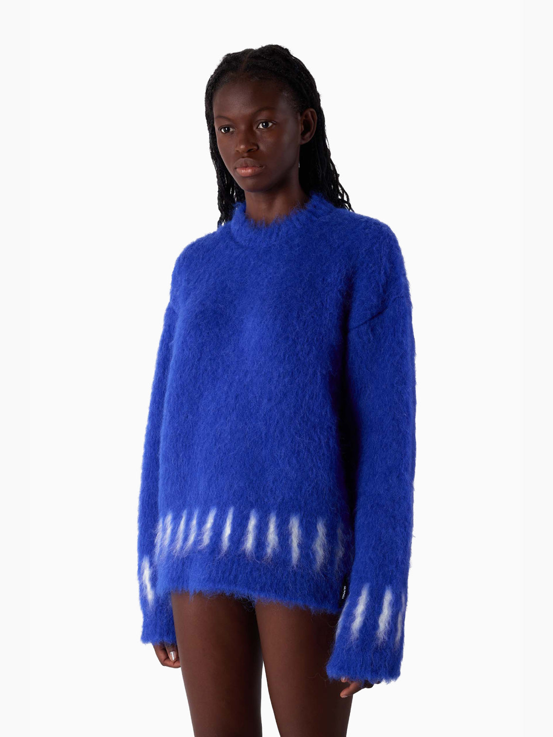 The Hairy Knit Sweater Electric Blue from Sunnei is a fuzzy piece crafted from Italian materials, showcasing white tie-dye patterns near the hem and cuffs. It is displayed against a plain white background and available in size S by Fatima.