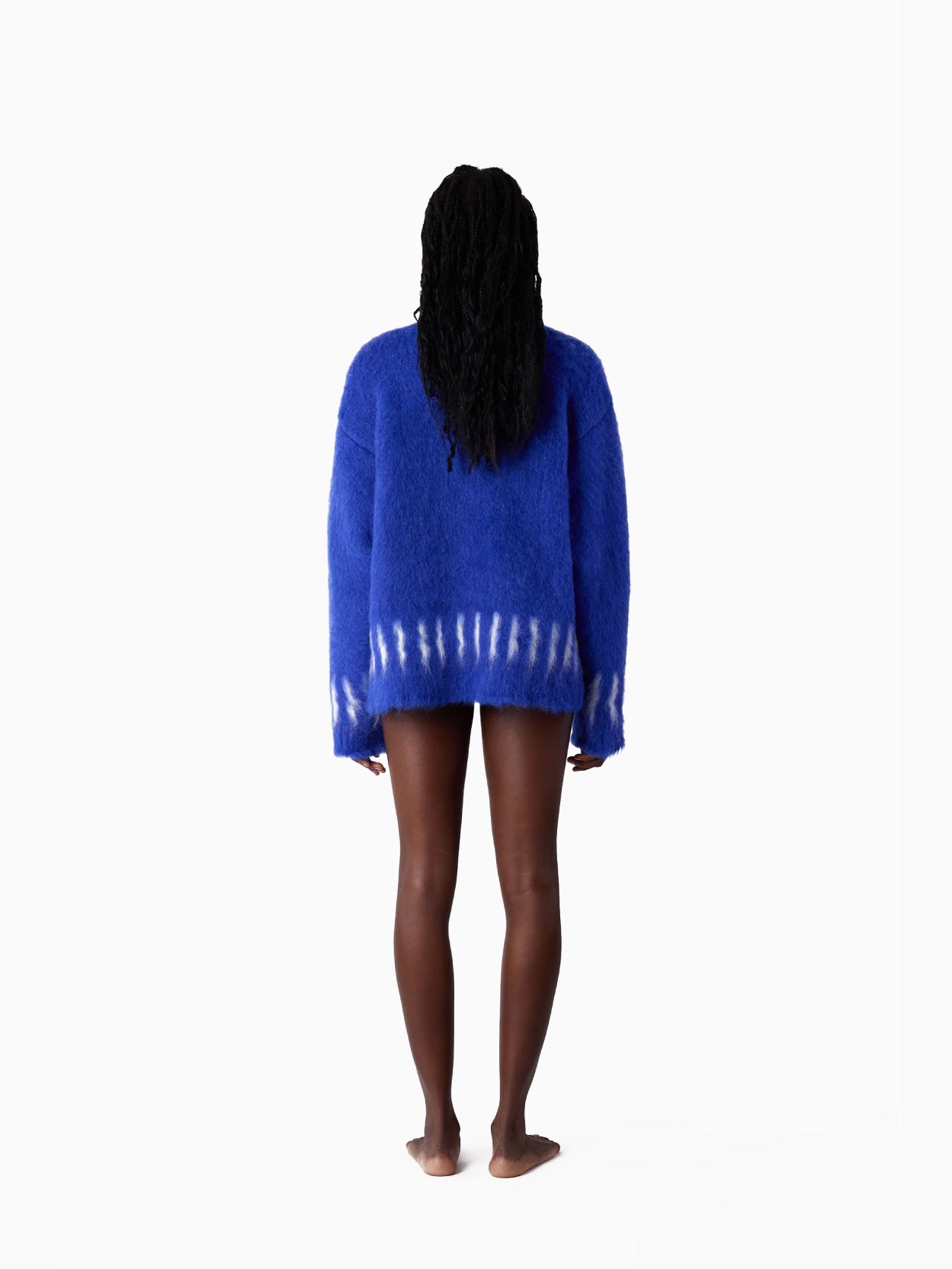 The Hairy Knit Sweater Electric Blue from Sunnei is a fuzzy piece crafted from Italian materials, showcasing white tie-dye patterns near the hem and cuffs. It is displayed against a plain white background and available in size S by Fatima.