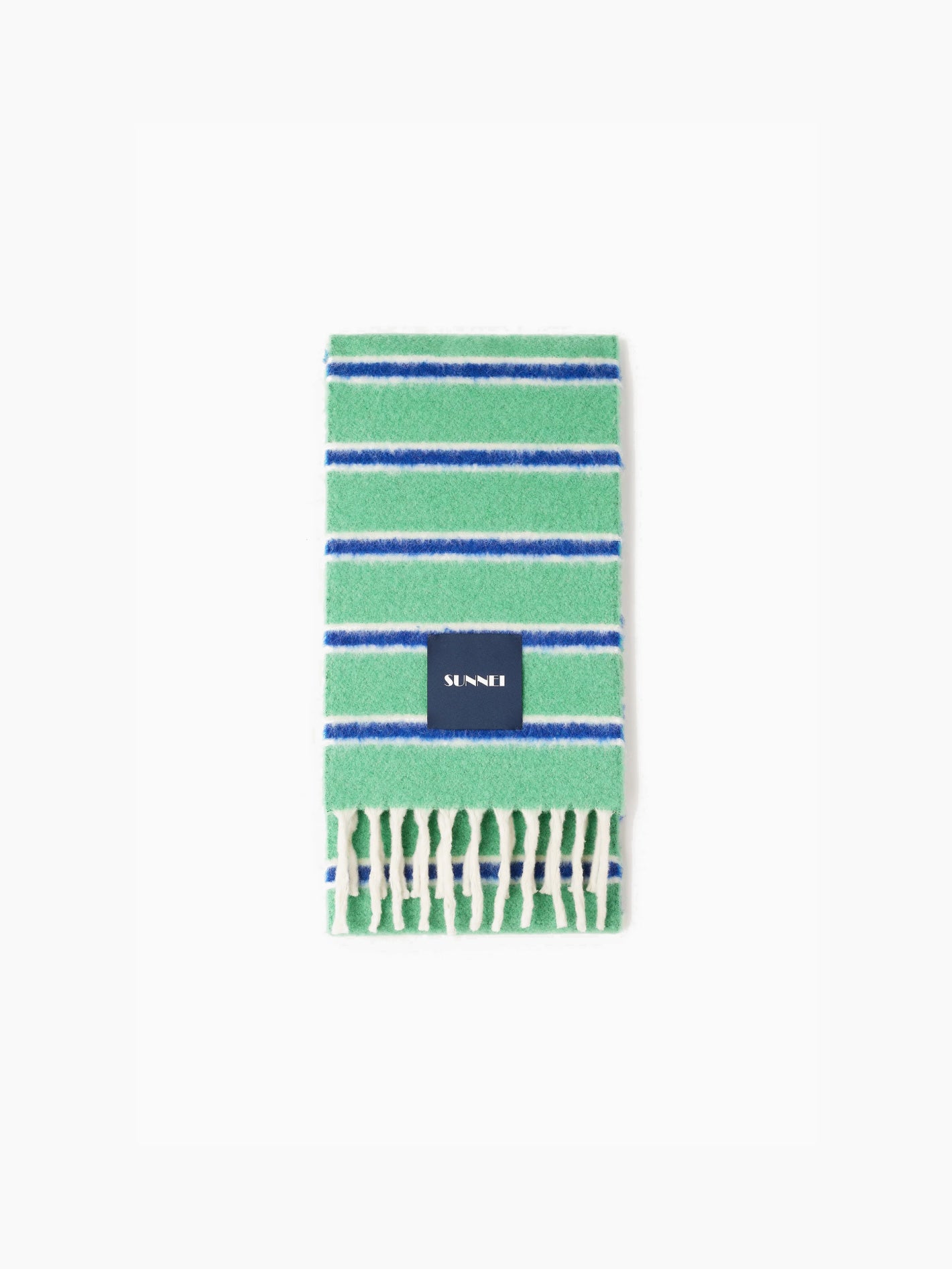 The Green Stripes Scarf by Sunnei, elegantly folded, is crafted from luxurious alpaca wool and features blue and white stripes against a green background. It rests gracefully on a white backdrop, boasting a black label with white text and finished with fringes at the end. Proudly made in Italy.