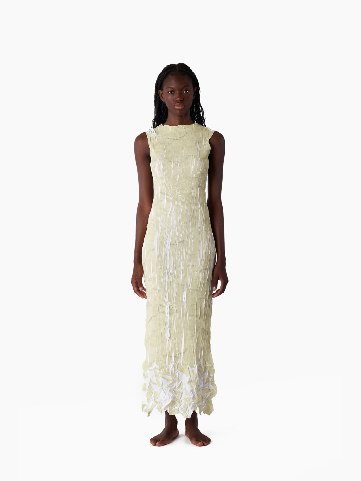 This is a sleeveless Pleated Long Dress by Sunnei, featuring a textured surface in light beige with ruffled details at the bottom, laid flat on a white background.