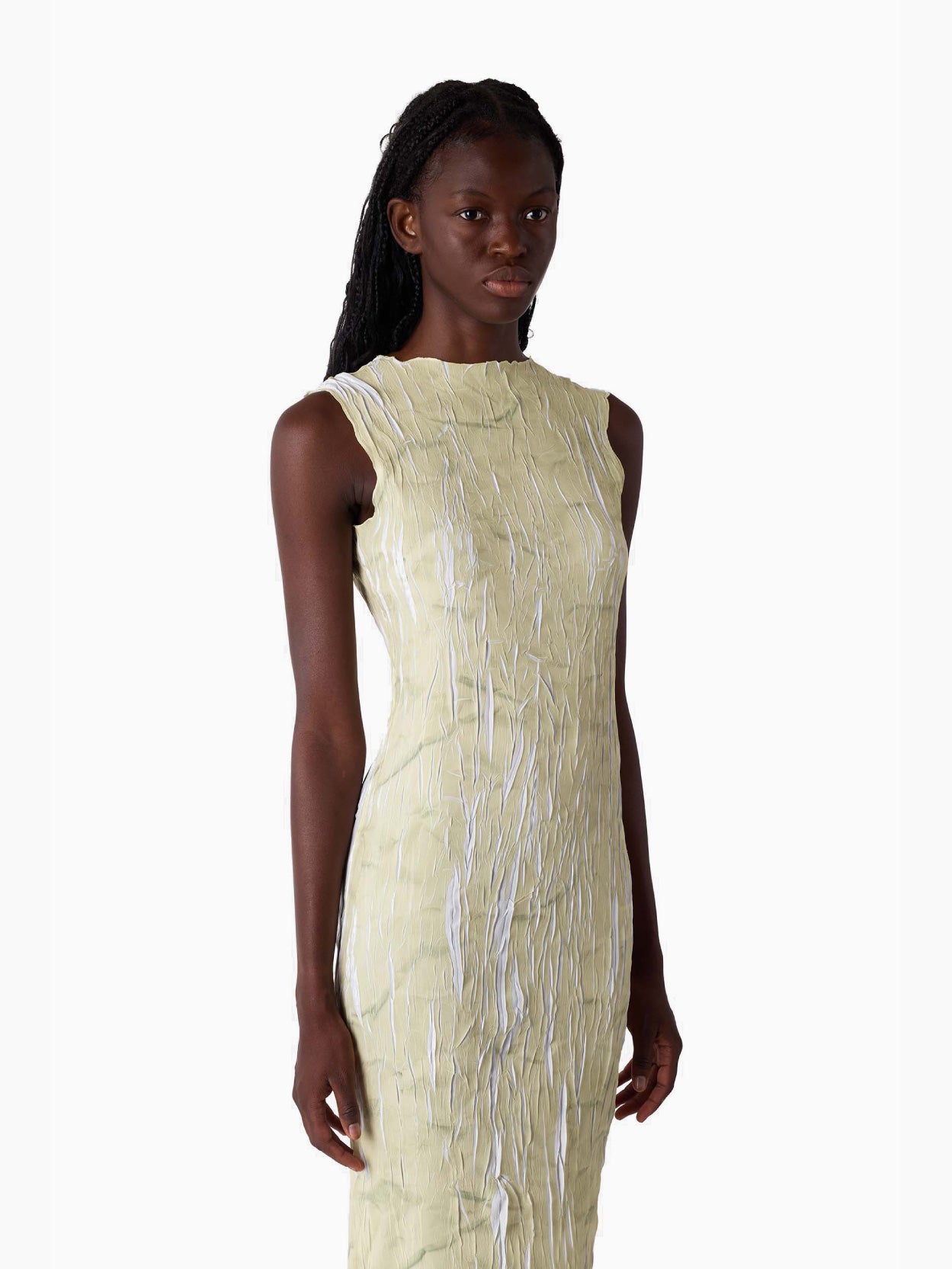 This is a sleeveless Pleated Long Dress by Sunnei, featuring a textured surface in light beige with ruffled details at the bottom, laid flat on a white background.