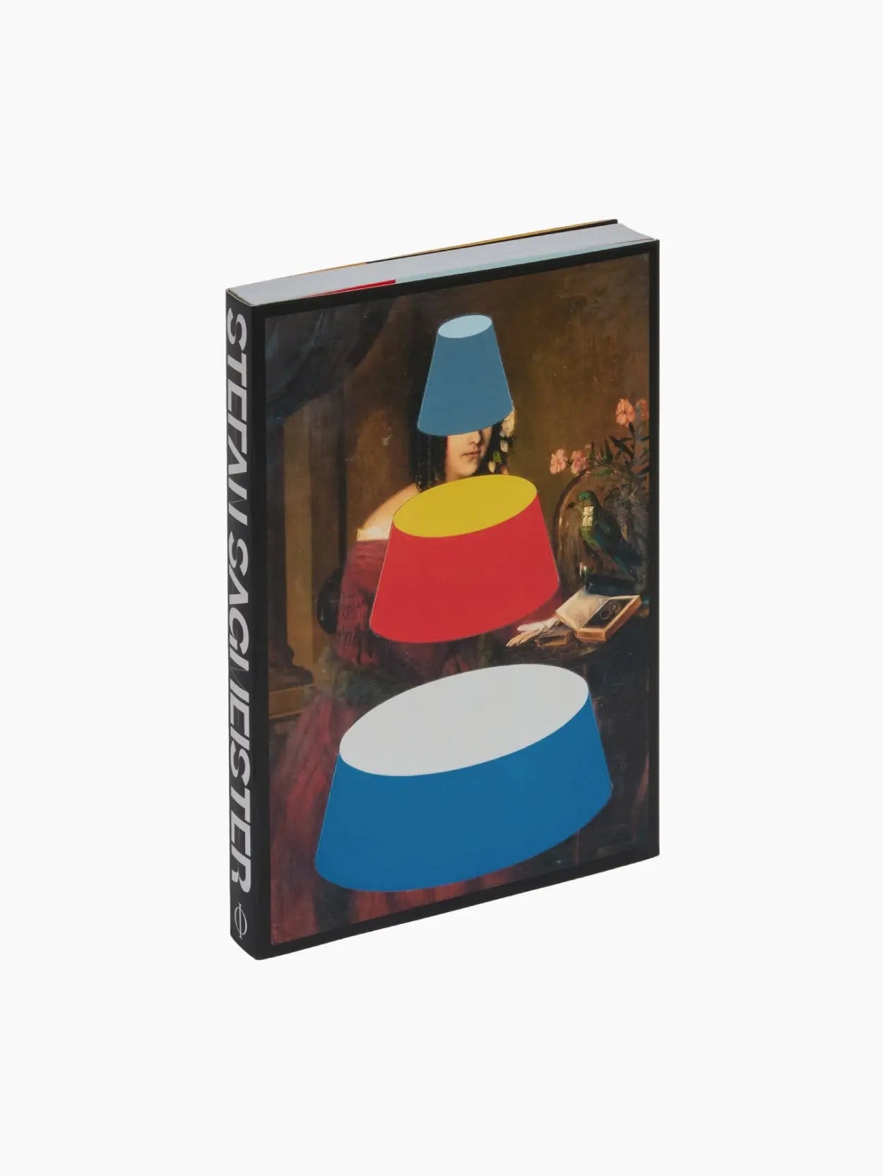 A book titled "Stefan Sagmeister: Now Is Better" by Phaidon stands upright against a white background. Its cover features artwork of a classical painting overlaid with graphic shapes: a blue cylinder, a yellow circle, and a red semicircular shape. Available at Bassalstore in Barcelona.