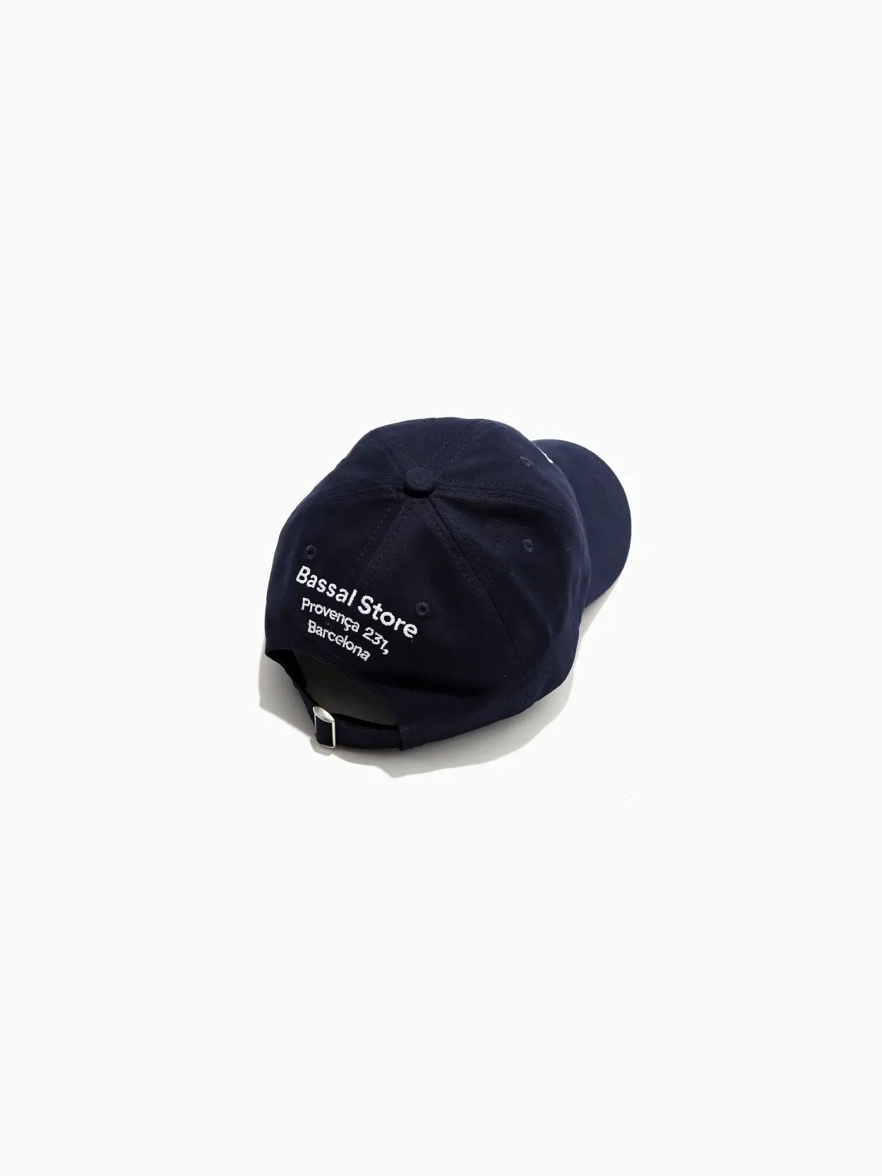 A Thank You, Come Back Cap Navy from Bassal Store with the text "Thank you, come back." embroidered in white on the front. The cap has a curved brim and six panels with stitching details. Perfect for your next visit to a bustling store in Barcelona.