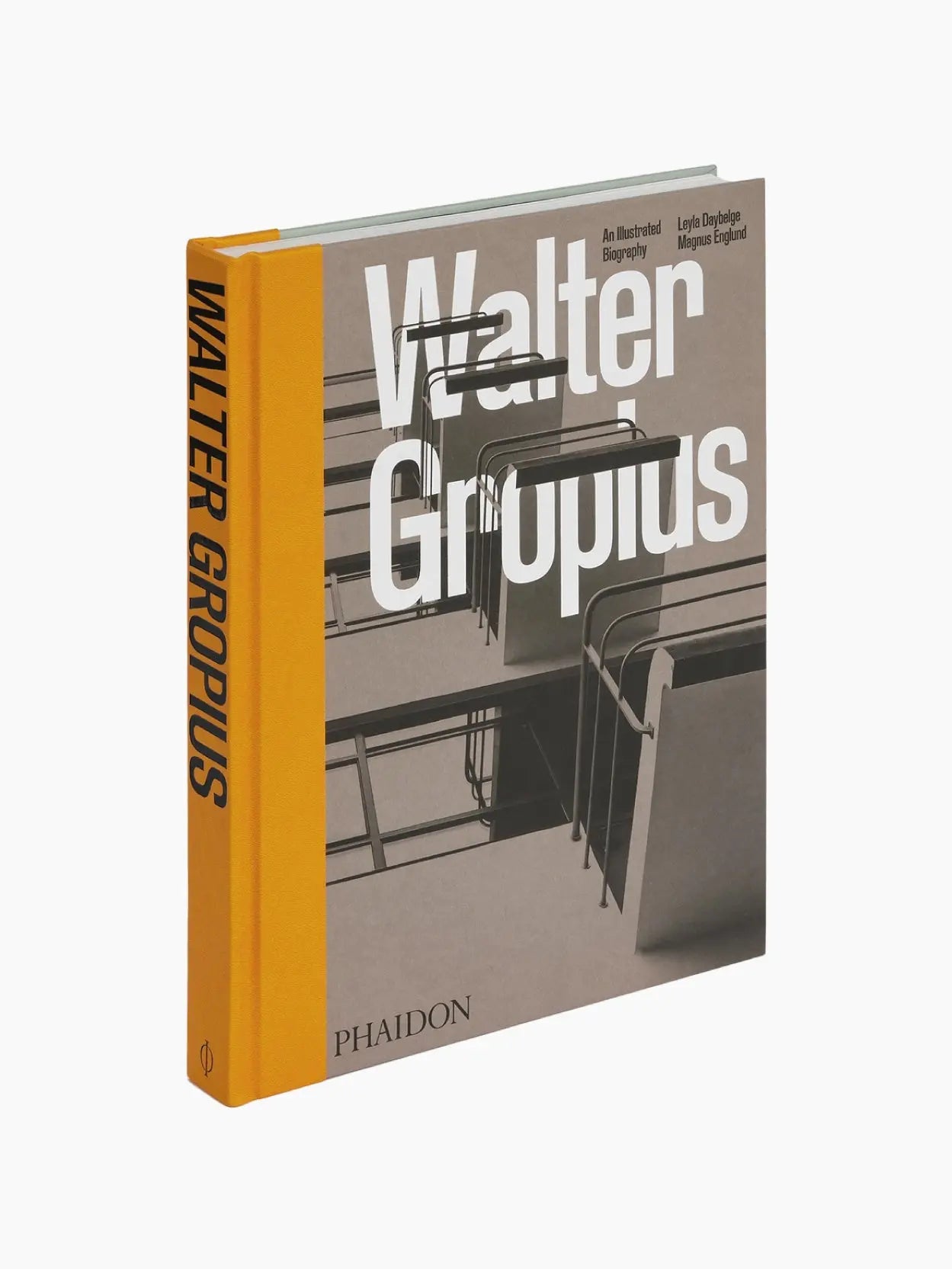 The image shows a book titled "Walter Gropius: An Illustrated Biography" with a hard cover, available at BassalStore. The spine is yellow with the title and the name "Phaidon" printed on it. The cover features a grayscale photograph of industrial-style furniture and the title in white bold letters, reminiscent of Barcelona's design ethos.