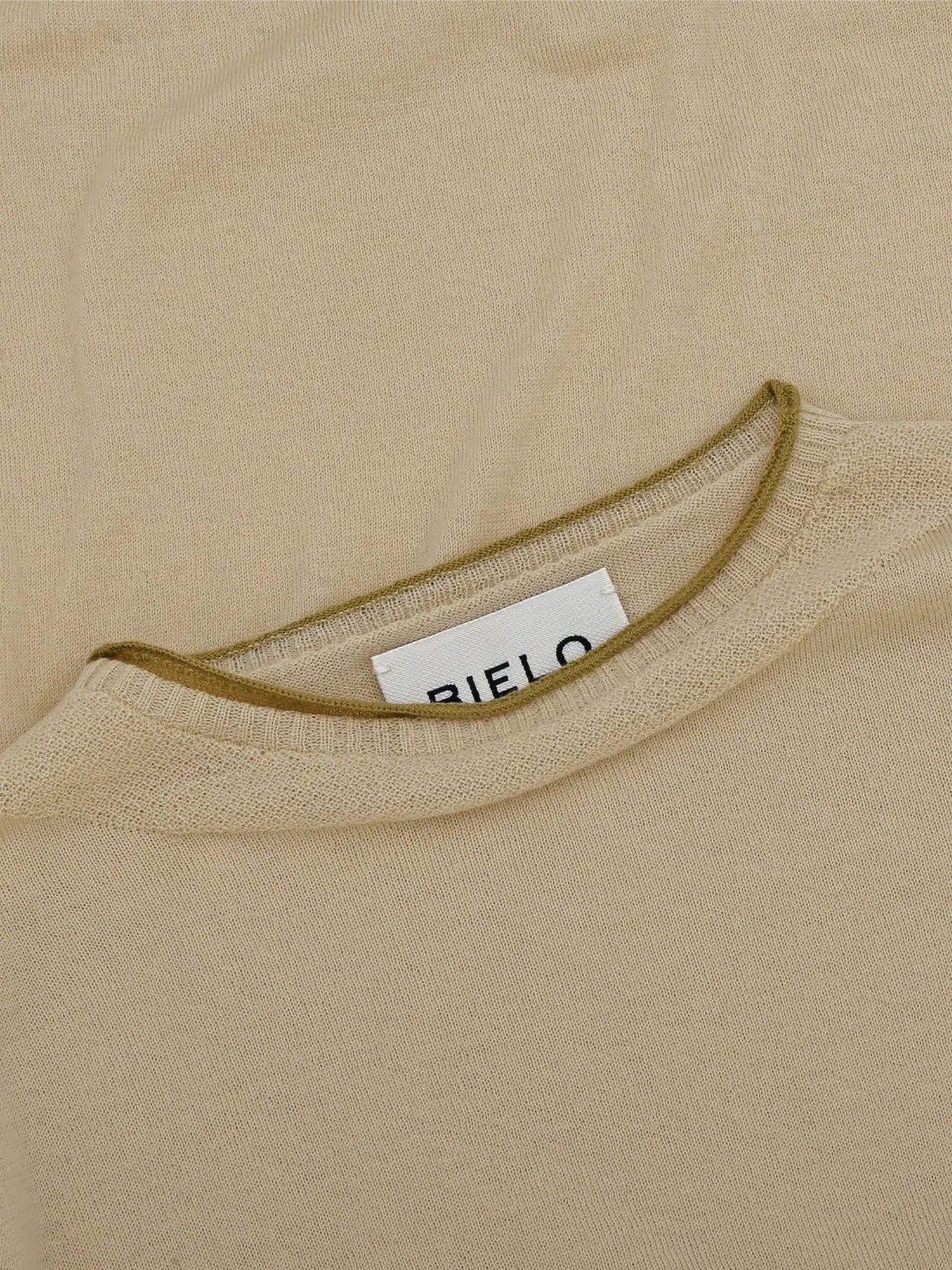 Beige, full-sleeve, crew-neck **Wist Sweater Cream** from **Bielo** laid flat on a white background. The sweater is plain with no visible patterns or designs. Discover timeless elegance with this essential piece from your favorite Barcelona-based store.