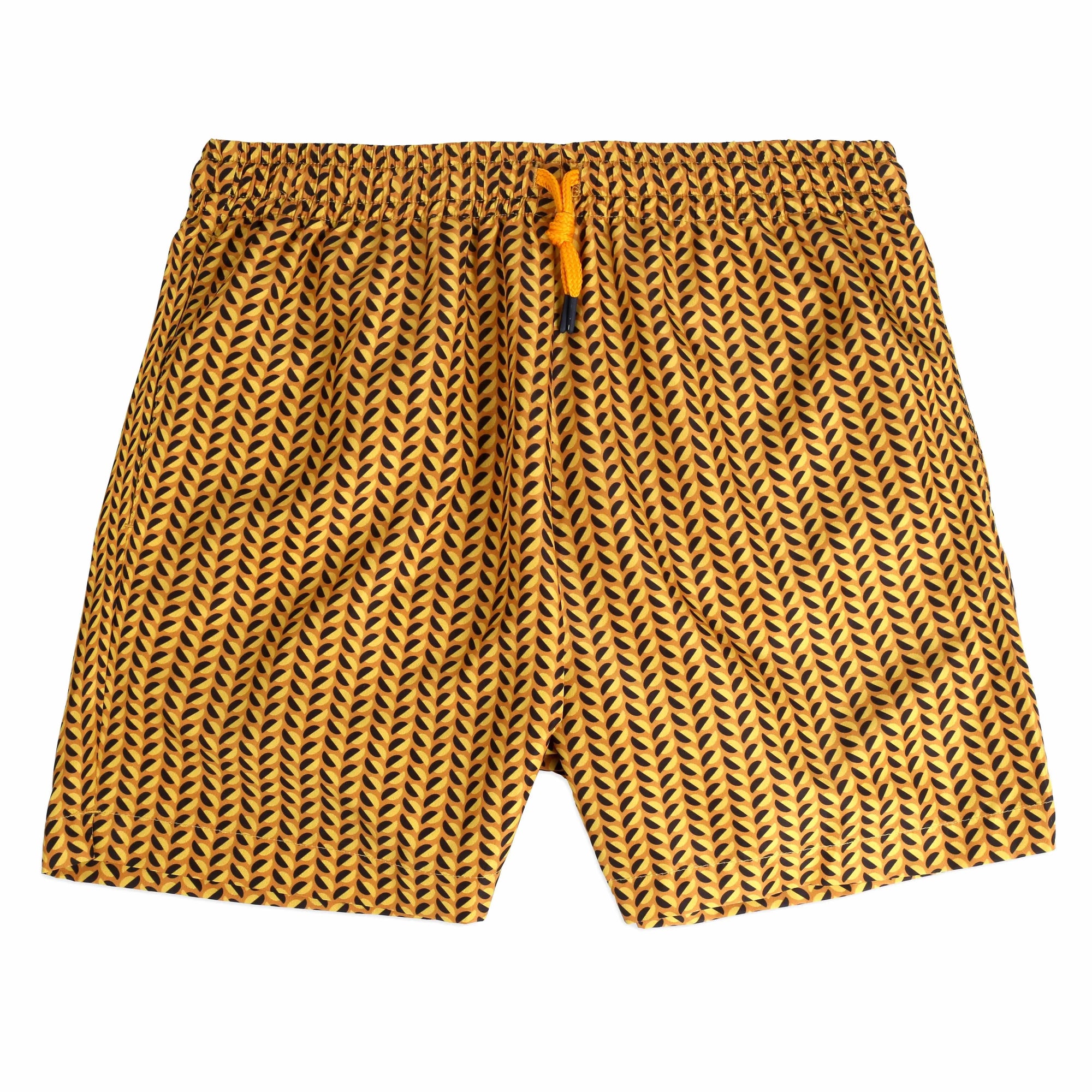 A pair of Clams yellow Swimwear featuring yellow and black leaf-like designs is neatly placed inside an open white box. The box lid, positioned on the left, showcases the brand name "Bassal." An orange cord is also visible, along with a tag featuring the brand name and "bassalstore" from Barcelona.