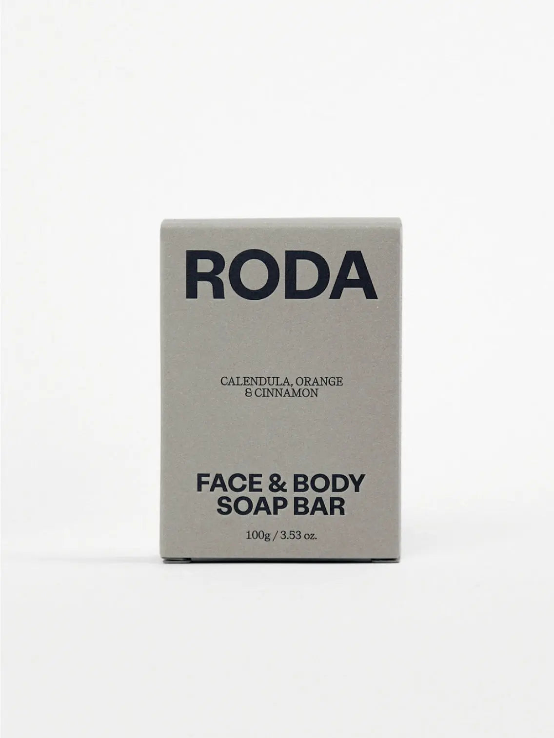 A rectangular beige Face & Body Soap Bar - Calendula, Orange & Cinnamon with the word "Roda" engraved on the top. The soap, available at Bassalstore, has small dark speckles distributed throughout, set against a plain white background.