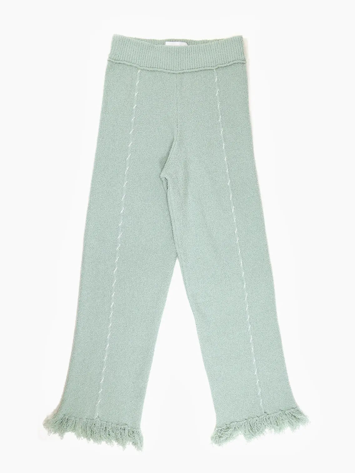 A pair of Hoki Pants Green by Rus with a ribbed waist and fringed hems, available at Bassalstore in Barcelona. The pants also feature vertical knitted seams along the legs.