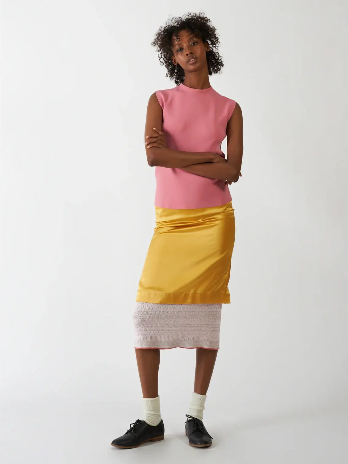A Bielo Neru Top Pink with a high neckline and a back zipper closure. The lightweight, slightly textured fabric is perfect for warm days. Laid flat against a white background, this chic piece is available at BassalStore in Barcelona.
