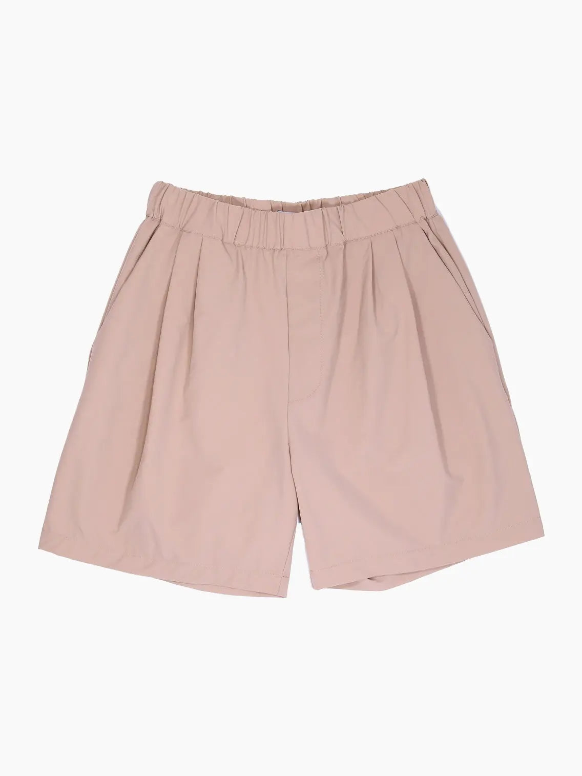 A pair of blush pink shorts with an elastic waistband and pleated front. The shorts are made from a light, flowy fabric and have a relaxed fit, perfect for casual wear. Discover Mundaka's Oversized Bermuda Beige at our Barcelona store for a chic addition to your wardrobe.