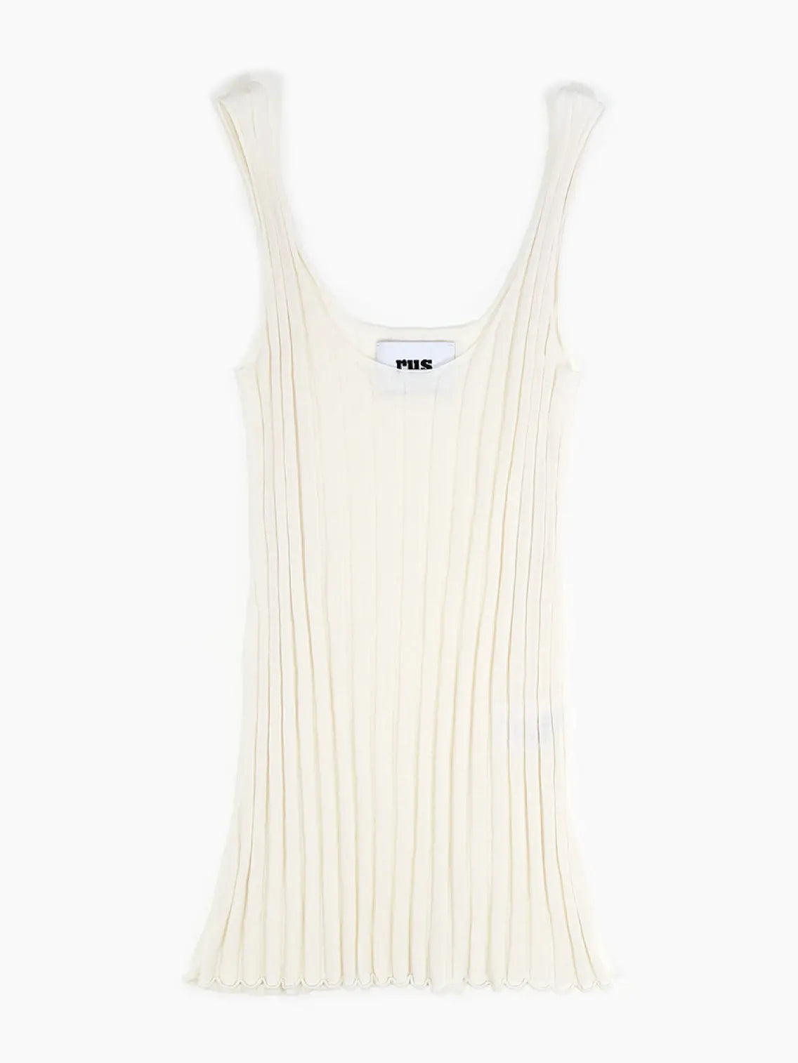 A Stella Top Chalk by Rus, sleeveless, cream-colored, ribbed knit dress with thin straps and a scoop neckline, laid flat on a white background. The dress has a fitted, slightly flared silhouette and features a small white label with black text on the inside of the back neckline. Available exclusively at Bassalstore in Barcelona.