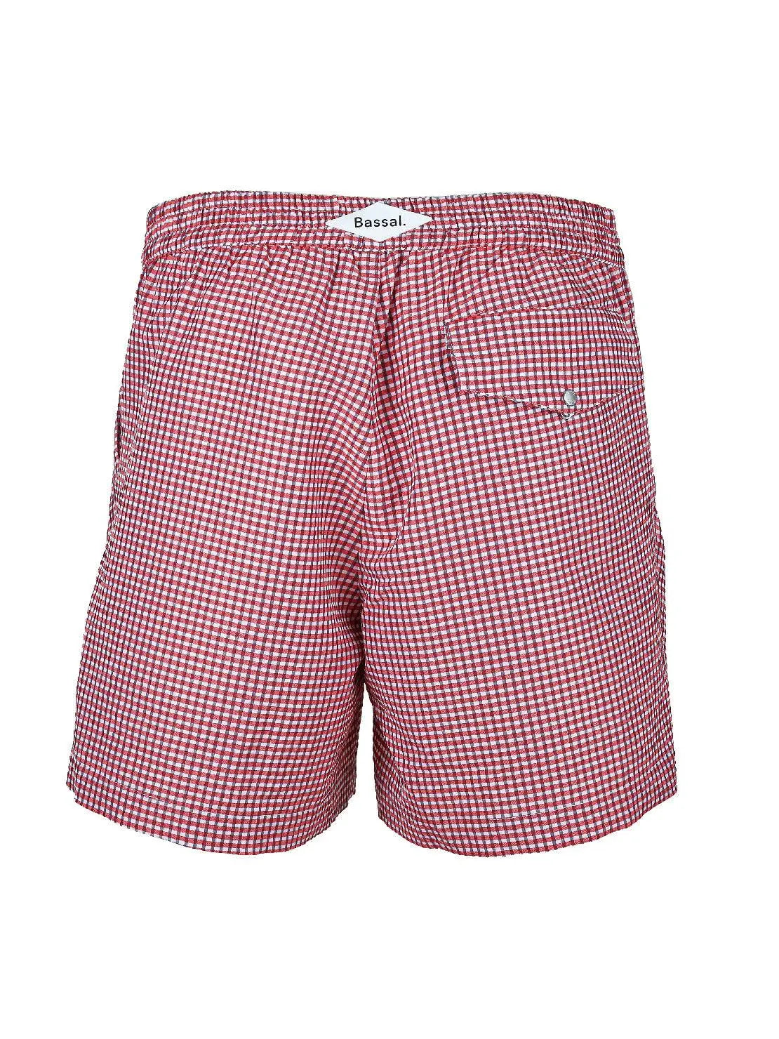 A pair of red and white gingham checkered Taia Red Swimwear with a high waist and pleats at the front, available exclusively at Bassalstore in Barcelona. These lightweight swimwear pieces feature two side pockets, making them ideal for casual summer wear.