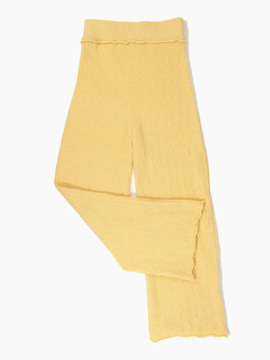 A pair of Tofu Pants Yellow from Rus with a flared leg from BassalStore. The waistband is ribbed, and the pants feature a subtle wavy pattern throughout. The fabric appears soft and cozy, suitable for casual or lounge wear.