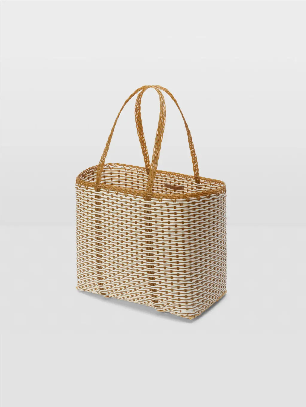 A rectangular wicker basket with two looped handles from Palorosa, featuring a white and natural brown woven pattern. The Trama Tobacco + White Bag is placed on a plain white background, highlighting its texture and craftsmanship inspired by the elegance of Barcelona.